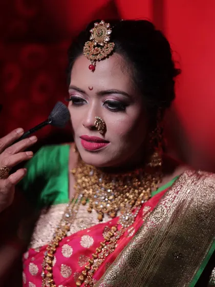 Here, I am demonstrating the correct way to apply finishing powder. This is a crucial step for setting makeup, controlling shine, and ensuring a bride's look stays fresh for hours.