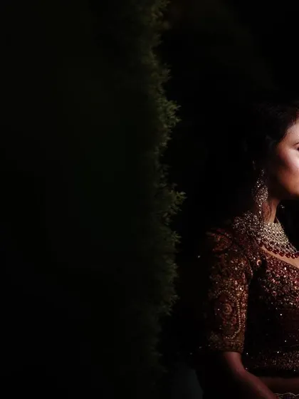 A moody and elegant bridal portrait from a reception. The dramatic side lighting creates a sophisticated and timeless look.