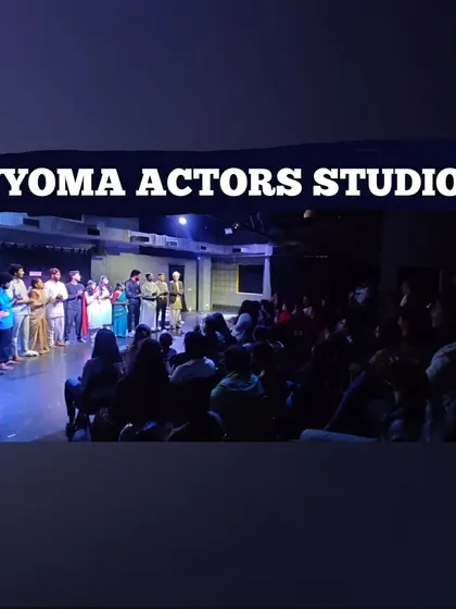 A wide shot of a student showcase, capturing the moment the cast receives their certificates on stage in front of a full house.