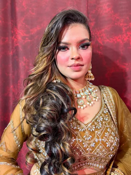 This look combines a dramatic smokey eye with soft, voluminous curls, creating a perfect balance of glamour and elegance for any evening event.