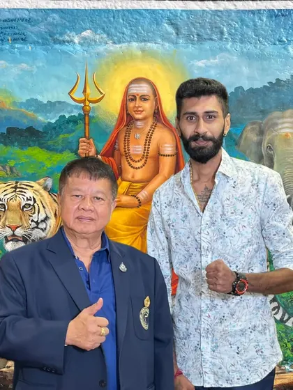With my godfather, Grand Master Woody, in front of a painting of a Hindu sage. My fighting philosophy is a blend of Thai martial tradition and my own deep-rooted faith.