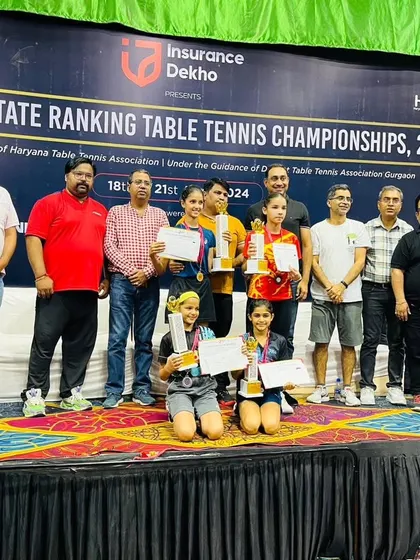 A group photo of the winners on stage at the Haryana State Ranking event. Our players consistently perform well, showcasing the high standard of coaching at our academy.