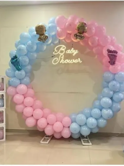 Celebrating a baby shower with a classic 'He or She' theme. We used a full circle balloon frame in pink and blue, with a 'Baby Shower' neon sign at the center. The setup is completed with 'It's a Boy' and 'It's a Girl' balloon columns and transparent 'BABY' display boxes.