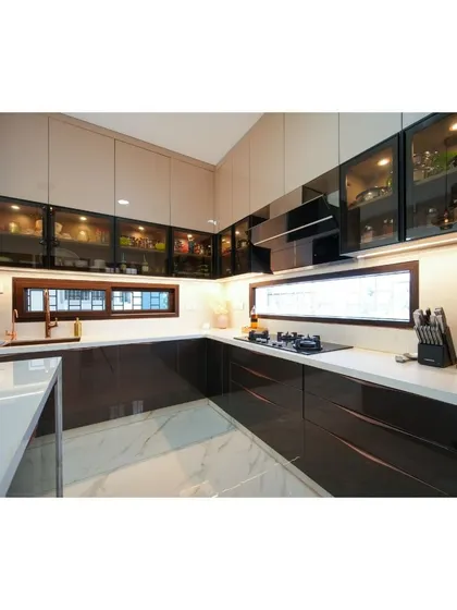 Tailored to the needs of my clients, this kitchen embodies functionality and elegance with its two-tone high-gloss cabinets, marble flooring, and ample counter space.