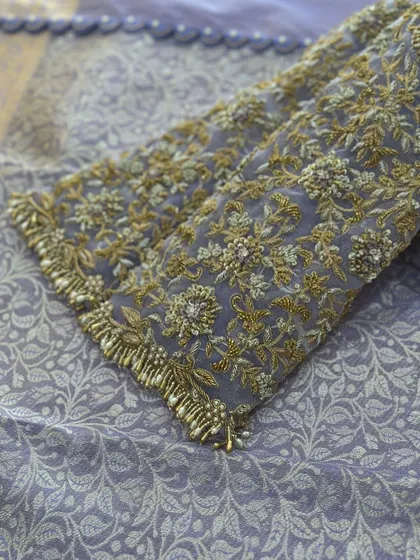 The sleeves of the lavender blouse, with all-over floral work.
