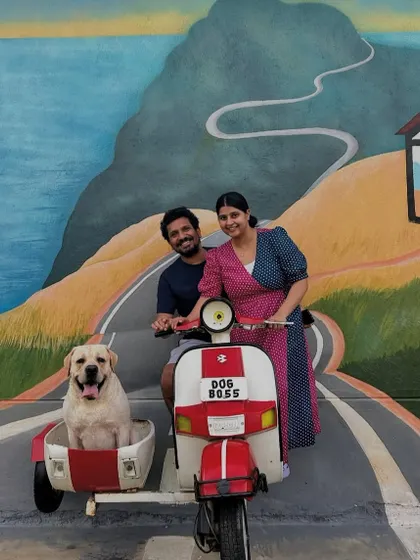 Creating picture-perfect moments is what we love. This family is all smiles, posing with their happy Labrador on our custom scooter photo prop.