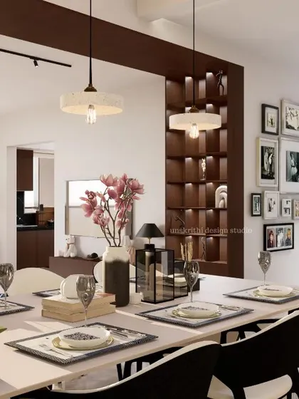 Here, the dining area looks back towards the living space, showcasing how different zones can be connected. We used a gallery wall to add a personal touch and a feature partition to create visual interest without closing off the space. The result is a cozy, layered, and inviting home.