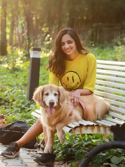 A sunny day on a park bench with Aaby the golden retriever and her person. This photo radiates the warmth and happiness pets bring into our lives.
