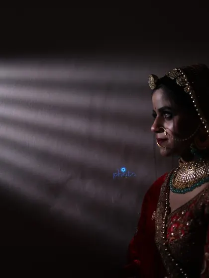 An artistic low-light bridal portrait using shadows and a single light source to create a dramatic and mysterious mood.