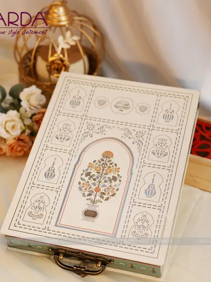 This beautiful keepsake box features a hand-painted floral motif inspired by Mughal art, set within a traditional arch design. The antique-style handle adds to its charm as a reusable decorative piece.