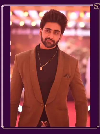 A close-up of the styling for Swaminathan. The combination of the shawl collar on the blazer and the simple chain accessory creates an effortlessly cool vibe for any formal event.