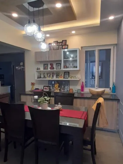 Another angle of the family dining room, showing the ample storage provided by the sideboard and the connection to the kitchen area.