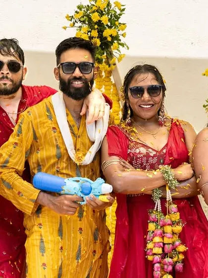The wedding party having fun with water guns, adding a playful and modern twist to the traditional Haldi ceremony.