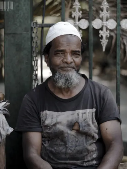 The streets are full of incredible faces and stories. This portrait of a man sitting by a gate captures a moment of quiet contemplation amidst the city's hustle.