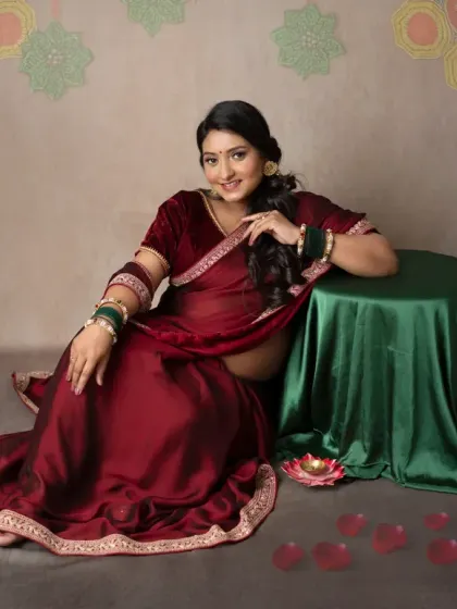 A traditional "dohale jevan" or godh bharai inspired portrait. The mom-to-be is surrounded by fruits and flowers, celebrating the abundance of new life.
