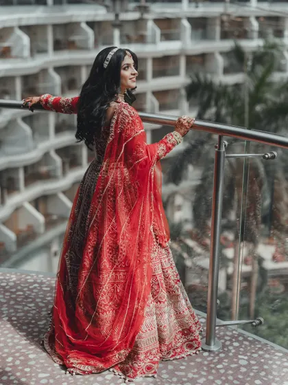 The bride enjoying a moment of reflection on the balcony, overlooking the venue. These solo portraits are a wonderful way to capture the anticipation and beauty of the wedding day.