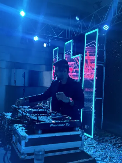 Lost in the mix under cool blue lights. This shot captures the focus and energy I put into every wedding DJ set.