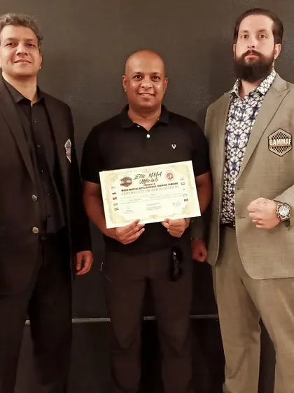 Posing with my Elite MMA Official certificate alongside the respected heads of AIMMAA and GAMMAF. Continuous learning is key.