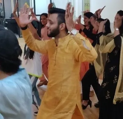 An instructor leading an impromptu dance session during the Diwali celebration.