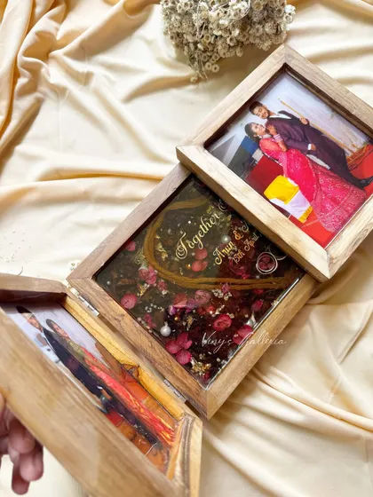 The three panels of the folding frame, each holding a piece of the couple's story. It's a unique and creative way to preserve wedding memories in a single, beautiful piece.