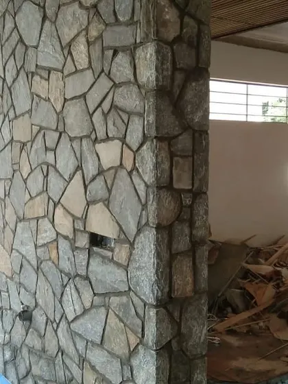 A stone-clad pillar during a renovation project. The natural stone texture provides a great contrast to smooth painted walls.