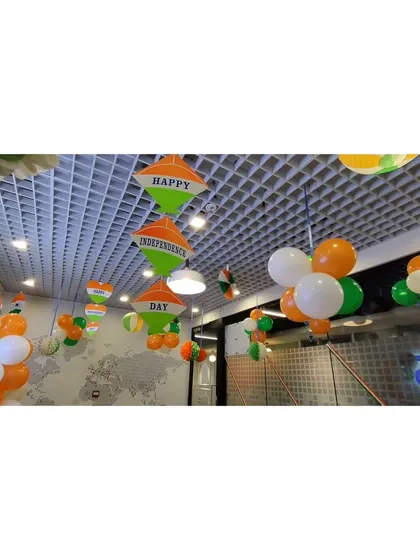 For the Independence Day celebration at DQS, I decorated the ceiling with tricolor balloon clusters and hanging paper fan decorations. This approach adds festivity to the entire room from above.