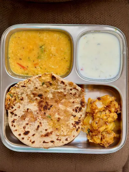 Another look at the delicious stuffed cauliflower paratha with dal, sautéed potato, and raita.