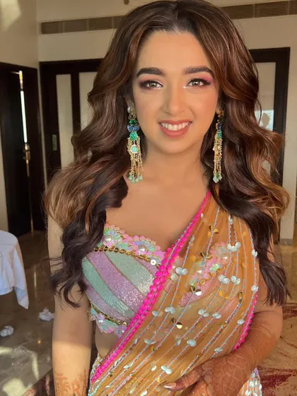 A vibrant and colorful Mehendi glam look. The bride's multi-colored outfit is the star, so I kept the makeup fresh and glowing with soft pink tones.