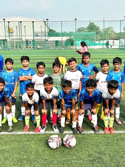 The full U-9 squad with their coaches, ready to implement the strategies discussed before the game.