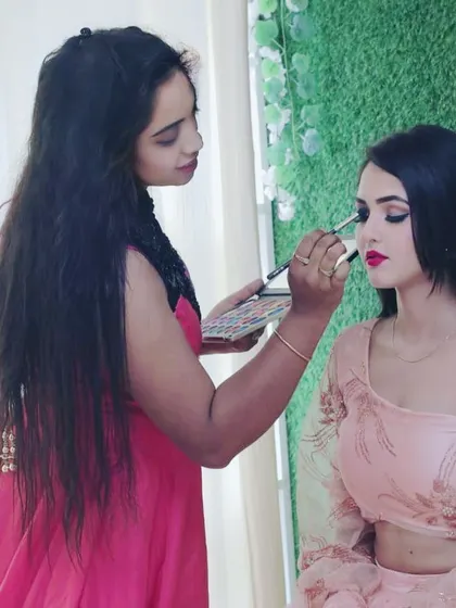 This is me in my element, working on a party glam look. In my course, you get direct guidance as you practice on live models, ensuring you understand every technique, from blending eyeshadow to achieving the perfect lip color.