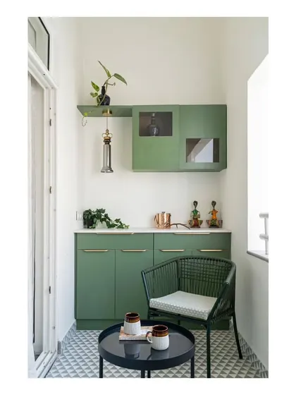 The private balcony attached to the home office, featuring a pantry, patterned flooring, and outdoor seating. It serves as a cozy spot to read a book or enjoy a cup of coffee.