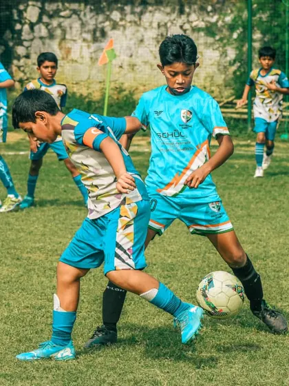 Two players from the same academy in a training match, pushing each other to improve.