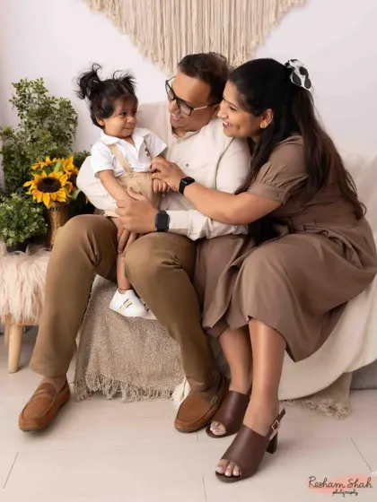 A cozy and candid moment during an indoor family session. The neutral tones and soft lighting create a warm, intimate portrait of this beautiful family.