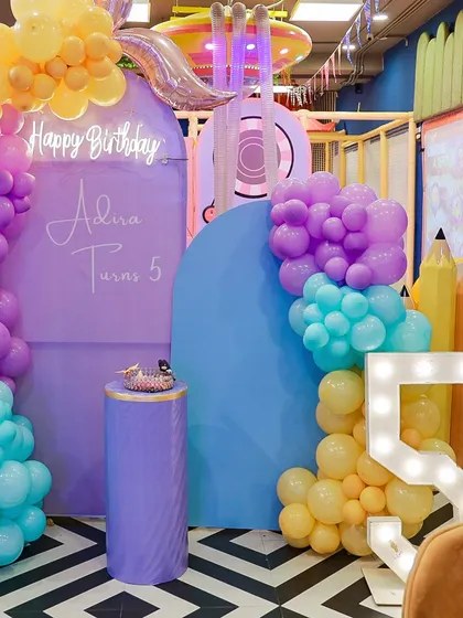 A wide view of the mermaid-themed party entrance, with a personalized welcome sign and elaborate balloon decor.