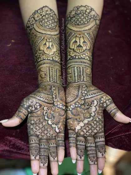 A full and intricate bridal design. The patterns are a beautiful mix of traditional motifs, creating a dense and rich look perfect for a wedding.