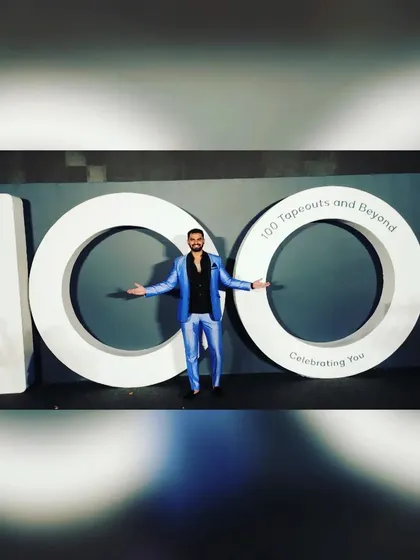 Posing with the impressive branding for Qualcomm's 100th tapeout event. I enjoy celebrating my clients' successes with them.