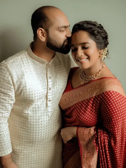 A sweet and simple engagement portrait, with the groom kissing the bride's forehead.