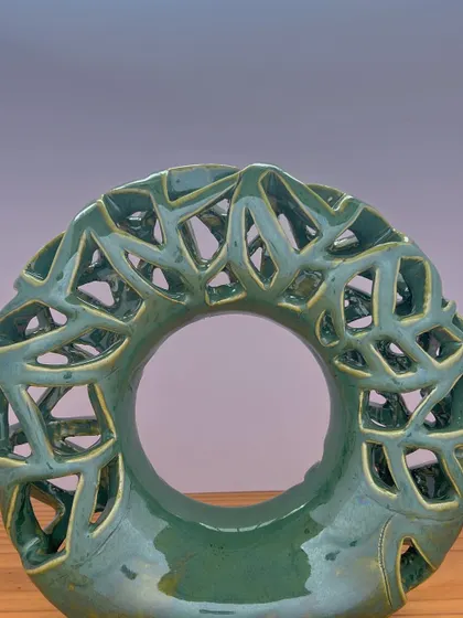 This "Emerald Falls" donut vase has an incredibly intricate carved texture. The green glaze breaks over the carving, creating beautiful depth and variation.