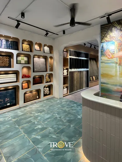 The reception area of my showroom, where a stunning art tile greets you. The curved desk and unique display alcoves are all part of the welcoming and inspiring atmosphere I strive to create for my clients.