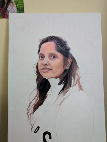 A work-in-progress shot of an acrylic portrait. You can see the grid method I use for accuracy and how I build up the skin tones and hair texture layer by layer.