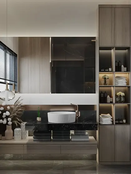 A well-appointed bathroom featuring a dark marble countertop on a floating vanity. A tall, integrated shelving unit offers a mix of open and closed storage for towels and toiletries.