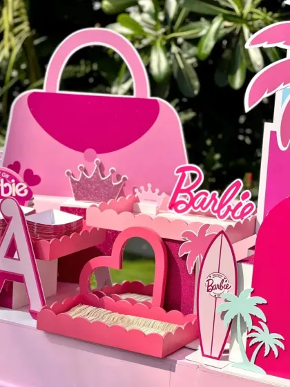 A closer look at the detailed props, including a Barbie handbag, crown, and surfboard cutouts.