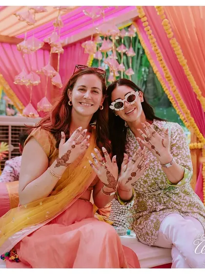 Guests showing off their beautiful henna designs at the Mehendi function.