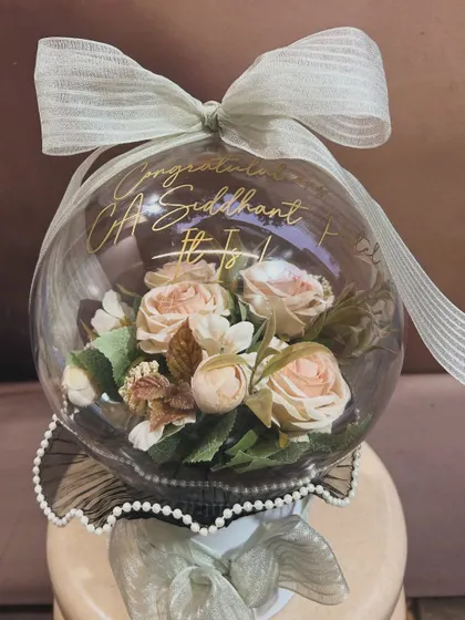 A unique way to say congratulations! This blooming acrylic bubble balloon was created to celebrate a new CA, Siddhant. The beautiful artificial flowers inside create a lasting and elegant keepsake.