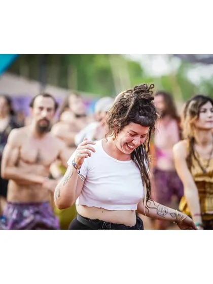 The pure joy of dancing. This woman's smile and movement perfectly capture the carefree and happy vibe of a daytime music festival.