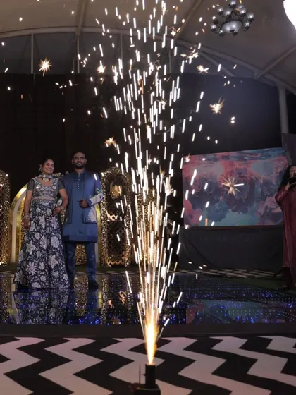 A dramatic entrance with a cold pyro sparkler creating a focal point. This is a fantastic way to add a 'wow' factor to the couple's entry and create a stunning photo opportunity.