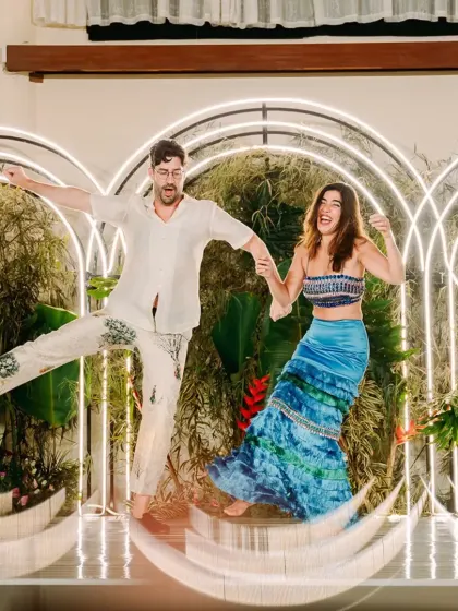 Pure joy and energy from the couple on the dance floor, perfectly captured against the modern, illuminated backdrop we designed for their Sangeet.