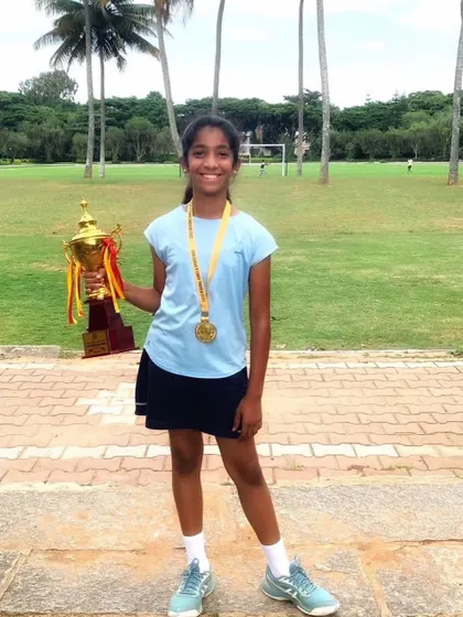 Our academy player Nysa proudly displays her gold medal and trophy after winning the doubles title for her school in the regional CISCE U-14 tournament.