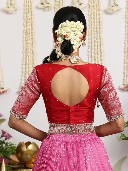 The back of the red blouse features a modern keyhole design, adding a contemporary touch to the outfit.