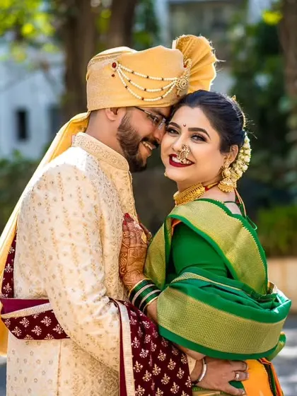 A bright, sunny outdoor portrait of a Maharashtrian couple. Their happy, relaxed expressions show the comfort and chemistry between them.